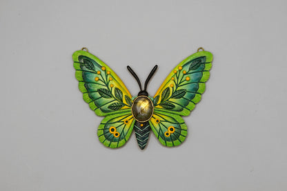 Green butterfly-shaped decorative item on a gray background