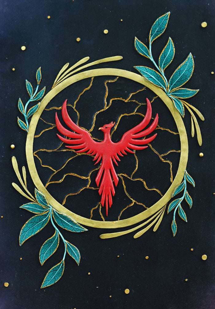 Red phoenix bird within a circular design with green leaves on a dark background