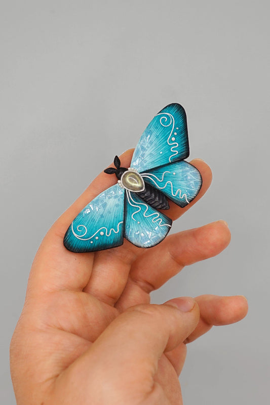 Icy moth brooch