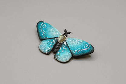 Icy moth brooch