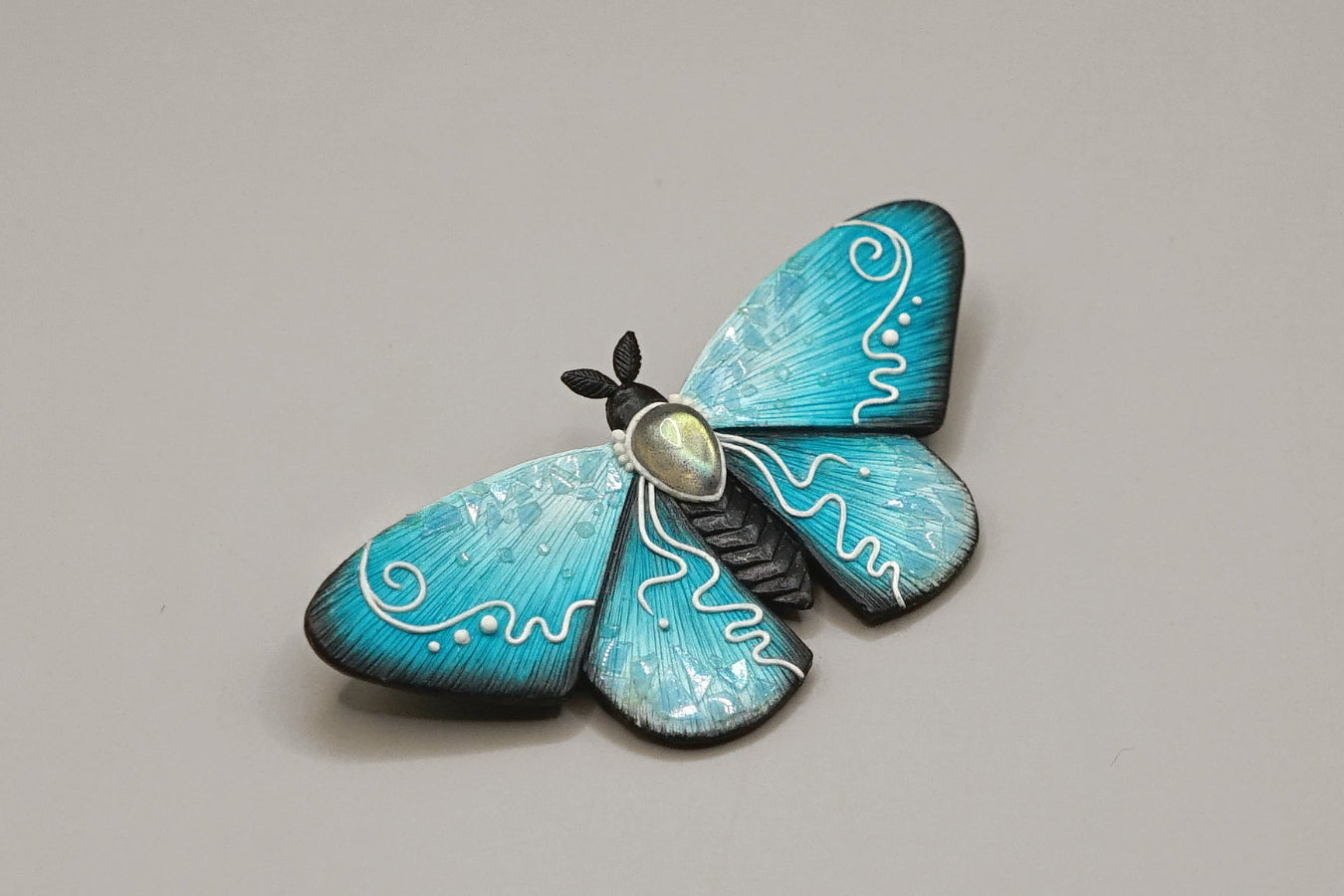 Icy moth brooch