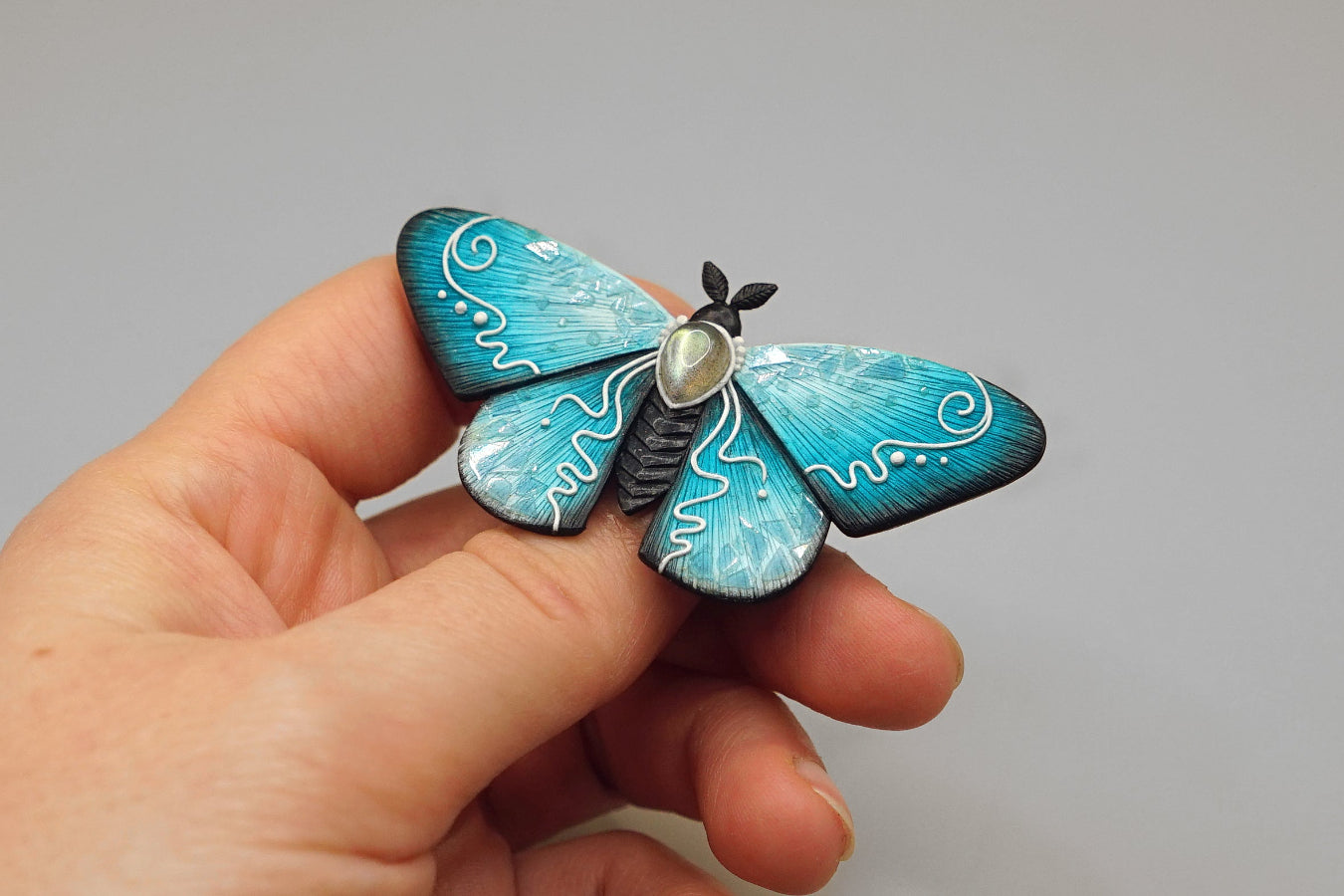 Icy moth brooch