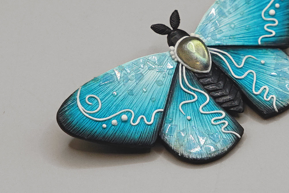 Icy moth brooch