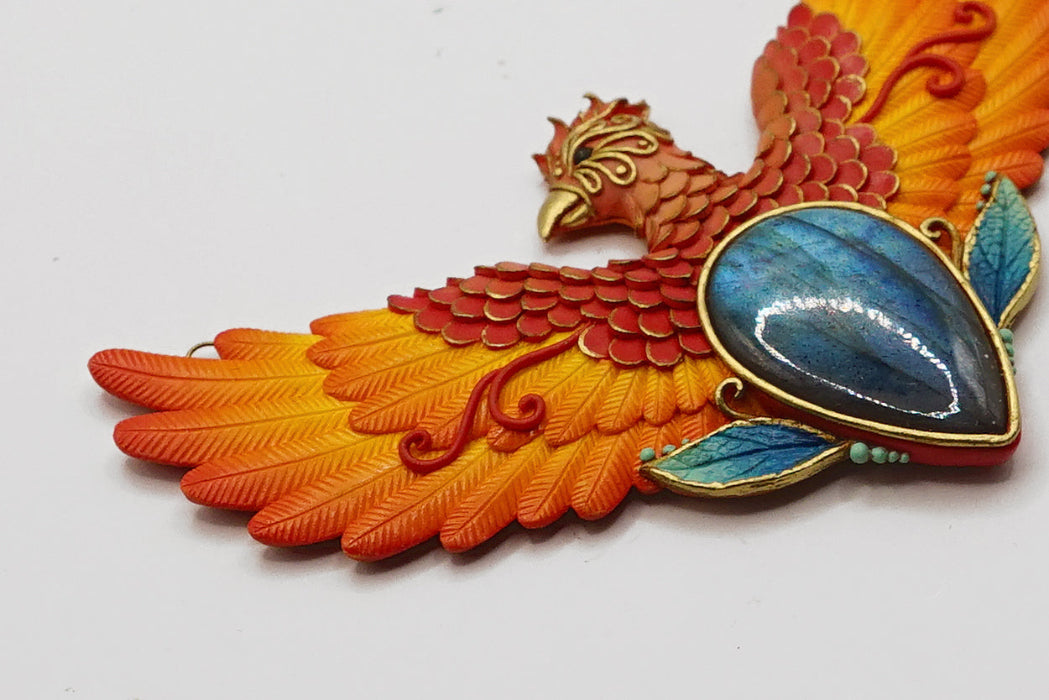 Decorative phoenix bird with blue stone on a white background
