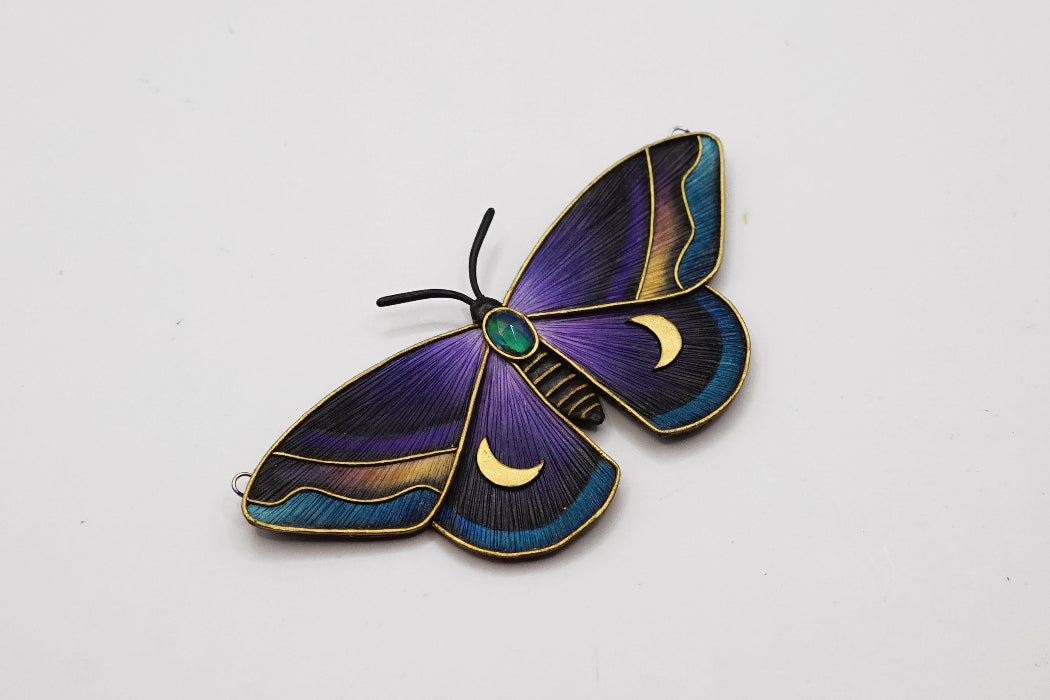 Decorative butterfly with purple and blue wings on a white background
