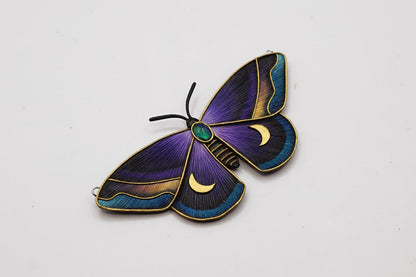 Decorative butterfly with purple and blue wings on a white background
