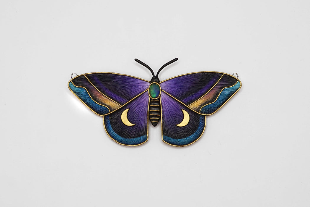 Decorative butterfly with purple and blue wings on a light gray background