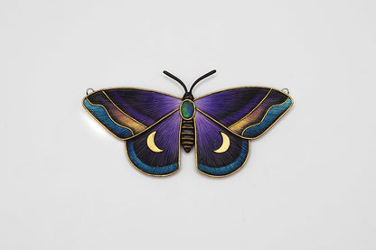 Decorative butterfly with purple and blue wings on a light gray background