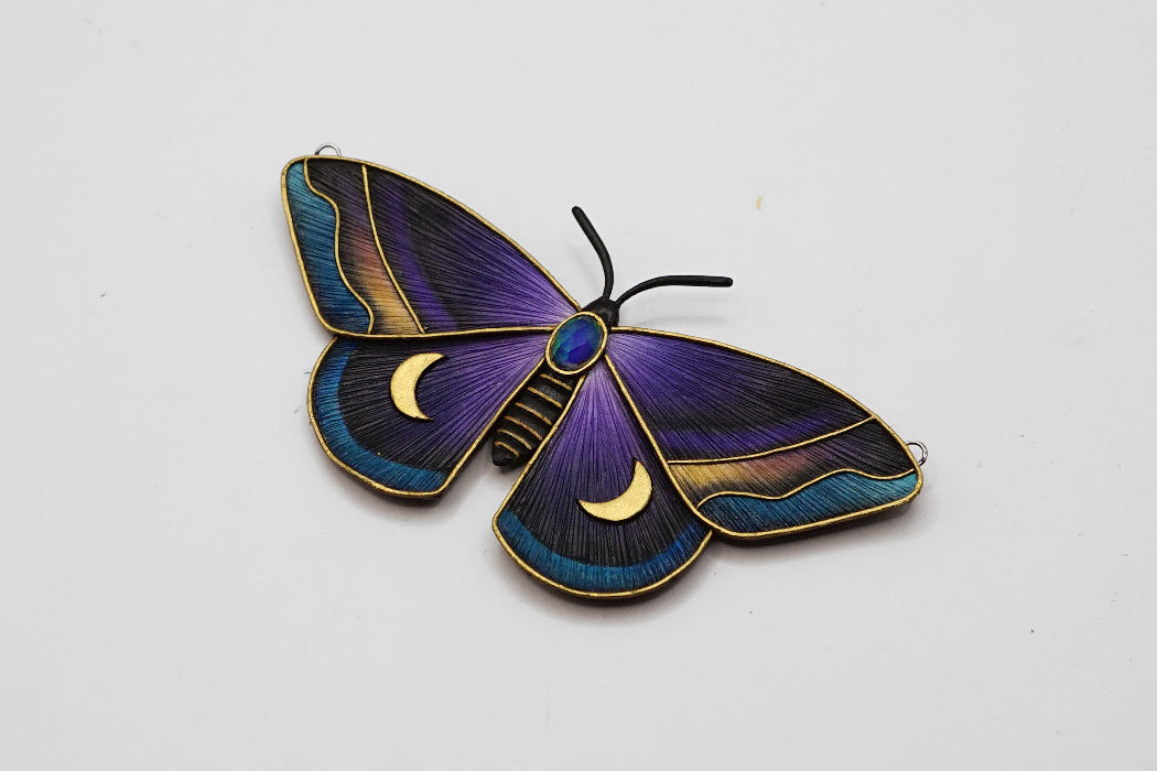 Decorative butterfly with purple and blue wings on a white background