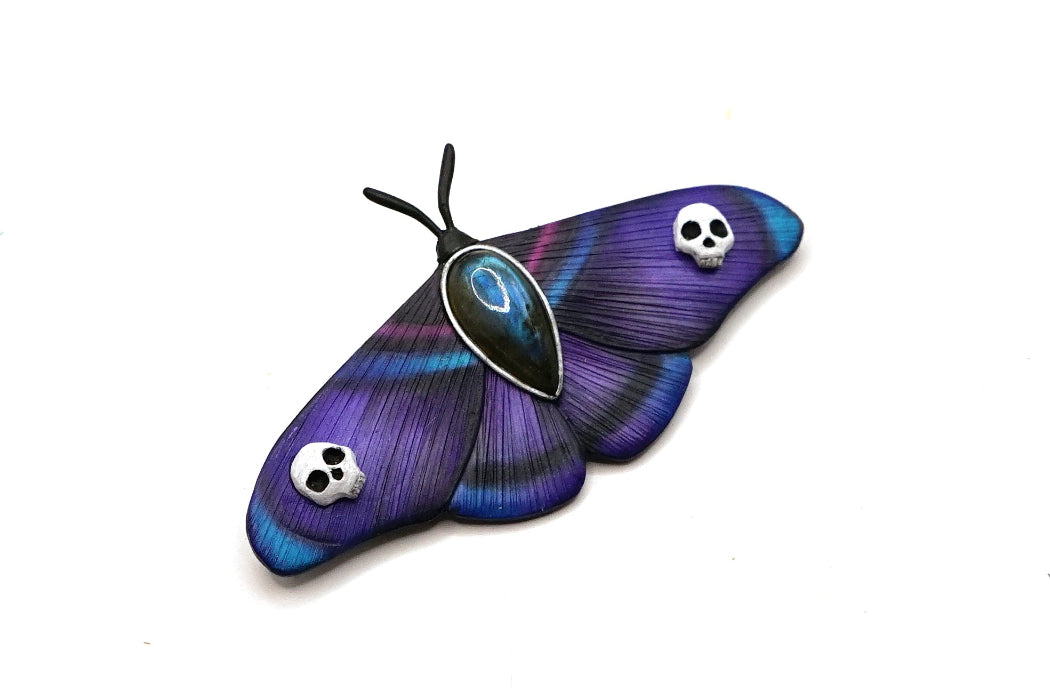 Purple butterfly with skull designs on a white background