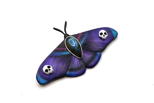 Purple butterfly with skull designs on a white background